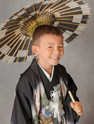 boy wearing hakama holding a wagasa