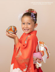 girl in kimono holding a temari